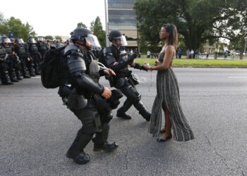 Lone activist Ieshia Evans stands her ground while offering her hands for arrest as riot police charge towards her during a protest against police brutality outside the Baton Rouge Police Department in Louisiana, U.S. on July 9, 2016. Evans, a 27-year-old Pennsylvania nurse and mother to a young boy, traveled to Baton Rouge to protest the shooting of Alton Sterling, a 37-year-black man and father of five, who was shot at close range while being held down by two white police officers. The shooting, captured on cell phone videos, aggravated the unrest that has coursed through the United States for two years over the use of excessive force by police, especially against black men. REUTERS/Jonathan Bachman