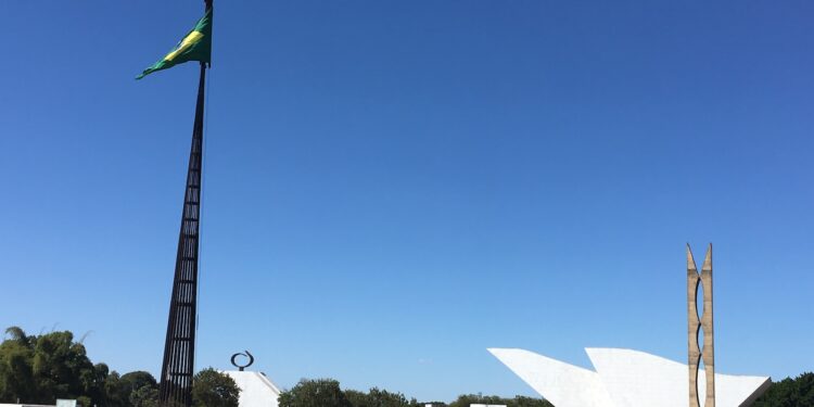 white and green flag on brown field under blue sky during daytime
