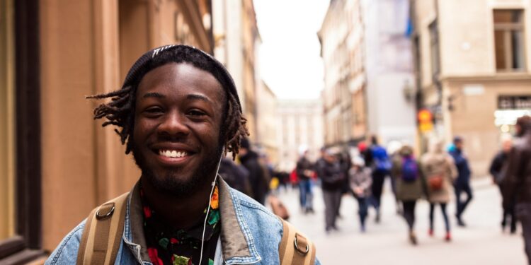 selective focus of man smiling near building