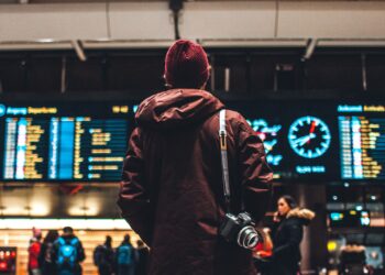 person looking up to the flight schedules