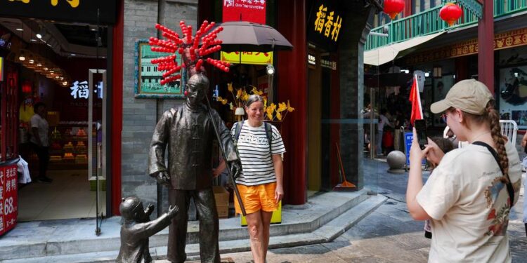 (240710) -- BEIJING, July 10, 2024 (Xinhua) -- A tourist from Switzerland poses for a photo on Qianmen Street in Beijing, capital of China, July 10, 2024.
  Currently, foreign nationals from 54 countries are eligible for the 72/144-hour transit visa-free policies that are effective at 38 ports in 18 provincial-level regions across China.
  China recorded 14.64 million inbound trips made by foreigners in the first half of this year, up 152.7 percent year on year, following measures introduced since January, the National Immigration Administration (NIA) announced on July 5.
  According to NIA, the number of visa-free entries made by foreigners exceeded 8.54 million from January to June, accounting for 52 percent of the inbound trips and representing a year-on-year surge of 190.1 percent. (Xinhua/Ju Huanzong)